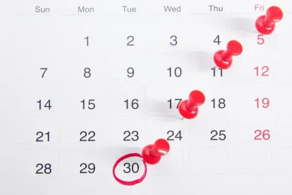 A calendar date pinned and circled with a red marker